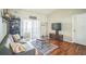 The well-lit living room offers wood floors and access to the patio through sliding glass doors at 2507 Dewberry St, Valrico, FL 33596