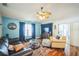 A comfortable living room features wood floors, blue accent walls, and lots of natural light at 2507 Dewberry St, Valrico, FL 33596