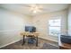 Bright office featuring chair railing, ceiling fan and desk with monitor overlooking neighborhood view at 2507 Dewberry St, Valrico, FL 33596