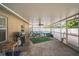 The covered outdoor space provides a casual area for dining and relaxing with grill and hammock at 2507 Dewberry St, Valrico, FL 33596