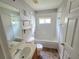White bathroom featuring a shower-tub combo, single vanity and a window at 2614 Queen Alberta Dr, Valrico, FL 33594