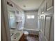 Bright bathroom with a tub/shower combo, neutral vanity, and a window, offering a serene and functional space at 2614 Queen Alberta Dr, Valrico, FL 33594