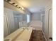 Bathroom featuring a double vanity, soaking tub, and a glass shower enclosure, providing ample space at 2614 Queen Alberta Dr, Valrico, FL 33594
