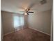 Bedroom featuring neutral walls, carpeting, and a window for natural light, creating a warm and inviting space at 2614 Queen Alberta Dr, Valrico, FL 33594