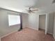 Bedroom features neutral walls, carpeting, and a window for natural light, creating a warm and inviting space at 2614 Queen Alberta Dr, Valrico, FL 33594