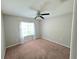 Neutral bedroom with a window letting in natural light and a ceiling fan at 2614 Queen Alberta Dr, Valrico, FL 33594