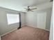 Cozy bedroom featuring neutral carpet, window, ceiling fan, and a closet at 2614 Queen Alberta Dr, Valrico, FL 33594