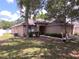Traditional one-story home with a well-kept lawn, mature trees, and a convenient two-car garage at 2614 Queen Alberta Dr, Valrico, FL 33594