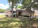 Traditional one-story home with a well-kept lawn, mature trees, and a convenient two-car garage at 2614 Queen Alberta Dr, Valrico, FL 33594