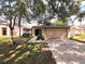 Charming single-story home with a two-car garage and mature trees shading the front yard at 2614 Queen Alberta Dr, Valrico, FL 33594
