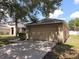 Spacious two-car garage with a concrete driveway and partial view of adjacent house at 2614 Queen Alberta Dr, Valrico, FL 33594
