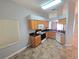 Functional kitchen with wood cabinets, black countertops, and essential appliances at 2614 Queen Alberta Dr, Valrico, FL 33594