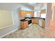Bright kitchen with light wood cabinets, black countertops, and a full suite of appliances at 2614 Queen Alberta Dr, Valrico, FL 33594
