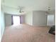 Spacious living room featuring neutral carpeting and a ceiling fan, filled with natural light at 2614 Queen Alberta Dr, Valrico, FL 33594