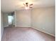 Spacious main bedroom with neutral carpet, ceiling fan, and en suite access at 2614 Queen Alberta Dr, Valrico, FL 33594