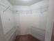 Walk-in closet with white walls, shelving, and beige carpeting to keep belongings organized and accessible at 2614 Queen Alberta Dr, Valrico, FL 33594
