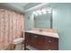Cozy bathroom featuring a vanity with marble counters, framed mirror, decorative sea shell shower curtain at 2650 Countryside Blvd # A210, Clearwater, FL 33761