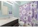 Bathroom featuring a white vanity sink and floral decorative shower curtain with a mirror at 2650 Countryside Blvd # A210, Clearwater, FL 33761