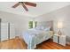 Comfortable bedroom with hardwood floors, a queen-sized bed, and soft natural light at 2650 Countryside Blvd # A210, Clearwater, FL 33761
