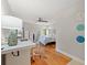 Bright bedroom featuring hardwood floors, a patterned bedspread, and a dedicated desk area at 2650 Countryside Blvd # A210, Clearwater, FL 33761