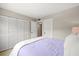 A bedroom featuring a large closet area and a lilac colored bed with decorative pillows at 2650 Countryside Blvd # A210, Clearwater, FL 33761
