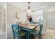 Charming dining area with wood table, blue chairs, and stylish decor, open to the kitchen at 2650 Countryside Blvd # A210, Clearwater, FL 33761