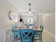 Cozy dining area featuring a wooden table with blue chairs and view into the kitchen at 2650 Countryside Blvd # A210, Clearwater, FL 33761