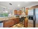 Kitchen featuring stainless steel appliances, tile backsplash, and breakfast bar at 2650 Countryside Blvd # A210, Clearwater, FL 33761