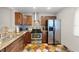 Kitchen boasting stainless steel appliances, tile backsplash, and stone countertops at 2650 Countryside Blvd # A210, Clearwater, FL 33761
