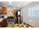 Kitchen highlighting stainless steel appliances, tile backsplash, and unique flooring at 2650 Countryside Blvd # A210, Clearwater, FL 33761