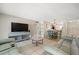 Open living space shows tv area, dining area, tile floors, and comfortable sofa at 2650 Countryside Blvd # A210, Clearwater, FL 33761
