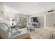 Spacious living room features tile flooring, a television and a comfortable sofa at 2650 Countryside Blvd # A210, Clearwater, FL 33761