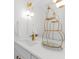 Stylish bathroom vanity with gold fixtures, modern lighting, and decorative display at 2700 Bayshore Blvd # 5210, Dunedin, FL 34698