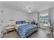 Cozy bedroom featuring a patterned duvet cover, modern chandelier, and natural light at 2700 Bayshore Blvd # 5210, Dunedin, FL 34698