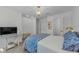 Relaxing bedroom with a patterned duvet, natural light, a TV, and classic furnishings at 2700 Bayshore Blvd # 5210, Dunedin, FL 34698