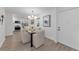 Bright dining area with a glass table, modern chandelier, and adjacent kitchen view at 2700 Bayshore Blvd # 5210, Dunedin, FL 34698