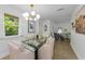 Modern dining area featuring a glass table with seating and views into the bright living spaces at 2700 Bayshore Blvd # 5210, Dunedin, FL 34698