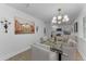Dining area with glass table, modern lighting, and view of the kitchen with stainless appliances at 2700 Bayshore Blvd # 5210, Dunedin, FL 34698