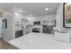 Contemporary kitchen with white cabinetry, stainless steel appliances, and a countertop breakfast area at 2700 Bayshore Blvd # 5210, Dunedin, FL 34698