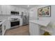 Bright kitchen featuring white cabinets, stainless steel appliances, and a breakfast bar at 2700 Bayshore Blvd # 5210, Dunedin, FL 34698