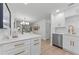 Bright kitchen showing island, white cabinets with gold handles, stainless steel appliances, and wood-look floors at 2700 Bayshore Blvd # 5210, Dunedin, FL 34698