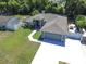 An aerial view of the home highlighting the manicured lawn, driveway and perimeter fencing at 2826 Martha Ln, Land O Lakes, FL 34639