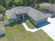 Bird's eye view of a charming home with landscaped yard, driveway, and an attached two-car garage at 2826 Martha Ln, Land O Lakes, FL 34639