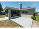 View of rear of home featuring screened-in patio and deck, enhancing outdoor living at 2826 Martha Ln, Land O Lakes, FL 34639