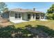 View of the backyard featuring lush green grass and a patio area at 2826 Martha Ln, Land O Lakes, FL 34639