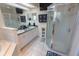 This spacious bathroom features double sinks, a large mirror, and a glass-enclosed shower with tile surround at 2826 Martha Ln, Land O Lakes, FL 34639