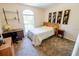 This sunlit bedroom provides a comfortable living space with a desk and decor for a relaxing atmosphere at 2826 Martha Ln, Land O Lakes, FL 34639