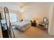 This cozy bedroom is filled with natural light and offers a comfortable queen size bed and ceiling fan at 2826 Martha Ln, Land O Lakes, FL 34639