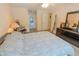 Bedroom with neutral colors and a comfortable bed setup and ensuite bathroom access at 2826 Martha Ln, Land O Lakes, FL 34639