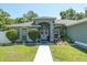 Welcoming front entrance with double doors, decorative wreaths, and manicured landscaping at 2826 Martha Ln, Land O Lakes, FL 34639